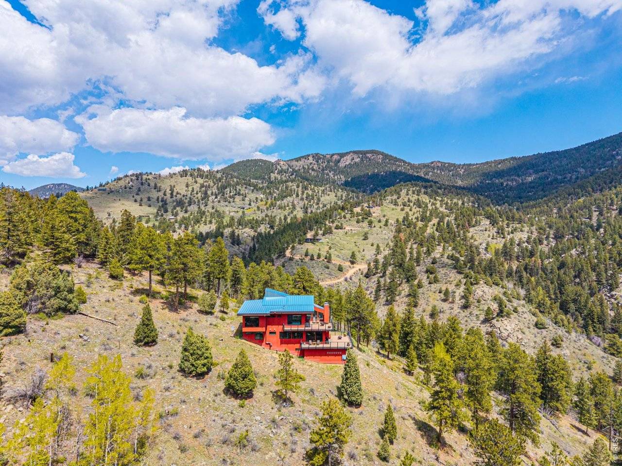A contemporary mountain home on a forested hillside above a valley near Golden, Colorado
