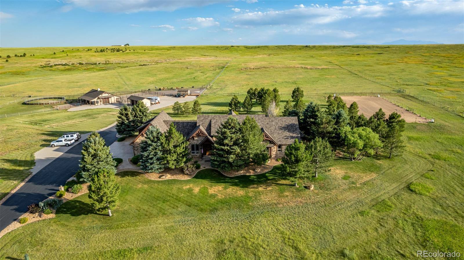 Aerial view of fenced pastures and an equestrian estate near Franktown, Colorado