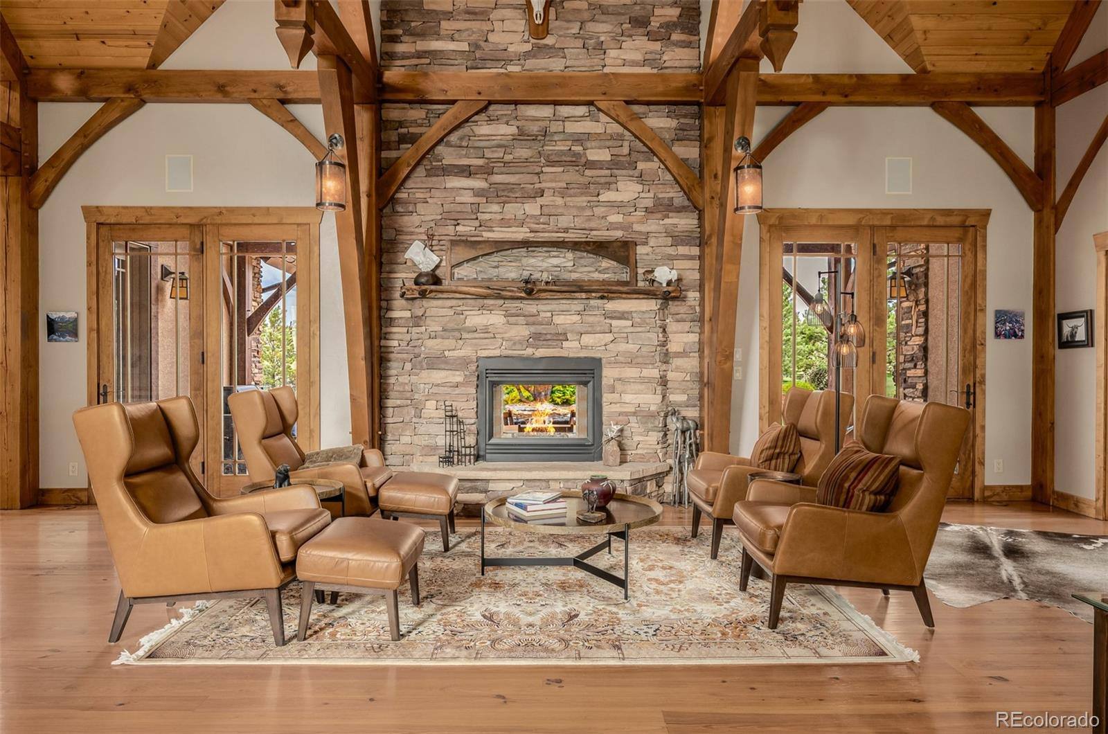 Great room with stone fireplace and leather chairs